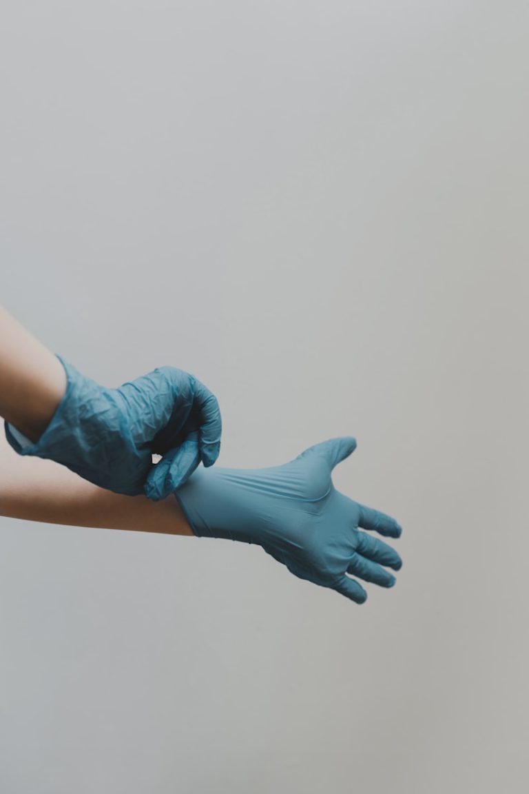 person in blue gloves