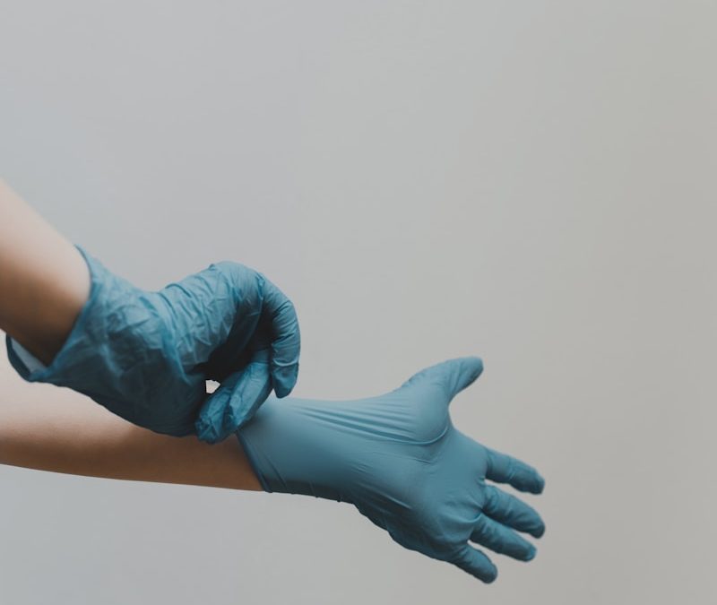 person in blue gloves
